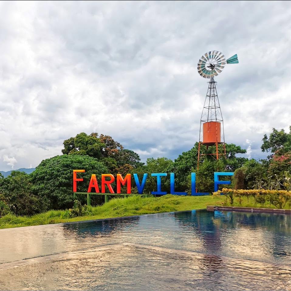 The Farmville sign and windmill beside the pool at Taal Maranan's Farmville